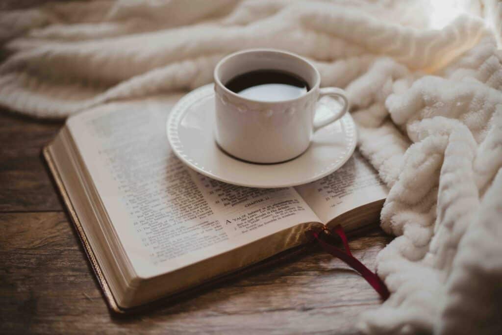 Teach Me Thy Way Bible sitting with coffee and a white blanket